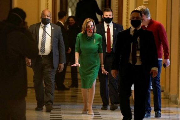Speaker of the House Nancy Pelosi (D-CA) walks back to her office after opening the House floor following an agreement of a coronavirus disease (COVID-19) aid package the night before on Capitol Hill, Washington, D.C., U.S., December 21, 2020. REUTERS/Ken Cedeno